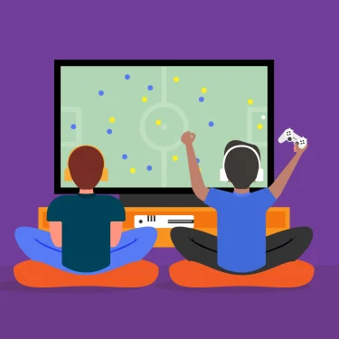 Two kids is sitting backward and facing the tv. They are playing TV game and one of them is raising his hands to show he is very excited.